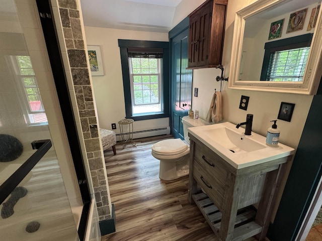 197 Circuit Rd, Ossipee, NH 03864 - bathroom featuring baseboard heating, wood finished floors, vanity, and a shower