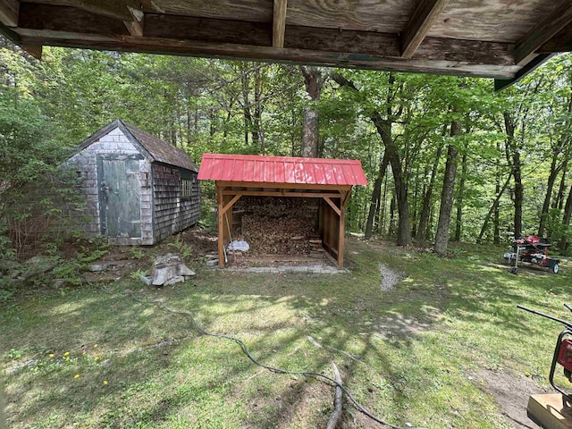 197 Circuit Rd, Ossipee, NH 03864 - view of grassy yard with a storage unit and a view of trees