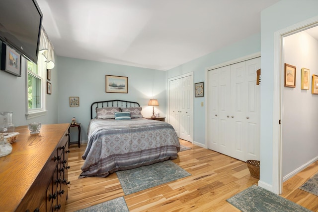 46 Pine Meadows Dr, Exeter, NH 03833 - bedroom featuring two closets and light wood finished floors