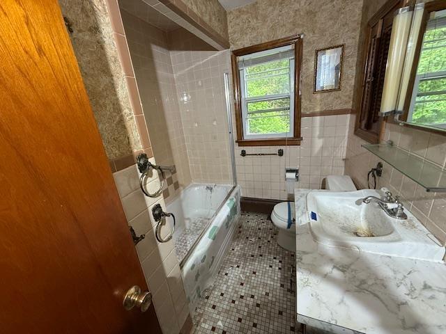 224 E Dunbarton Rd, Goffstown, NH 03045 - bathroom featuring tile walls, vanity, a wainscoted wall, tile patterned floors, and bathing tub / shower combination