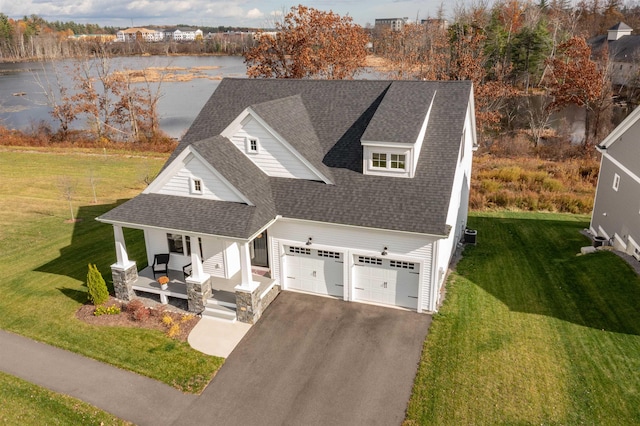 21 Catesby Ln, Londonderry, NH 03053 - view of front of house featuring covered porch, asphalt driveway, a shingled roof, a water view, and a front yard