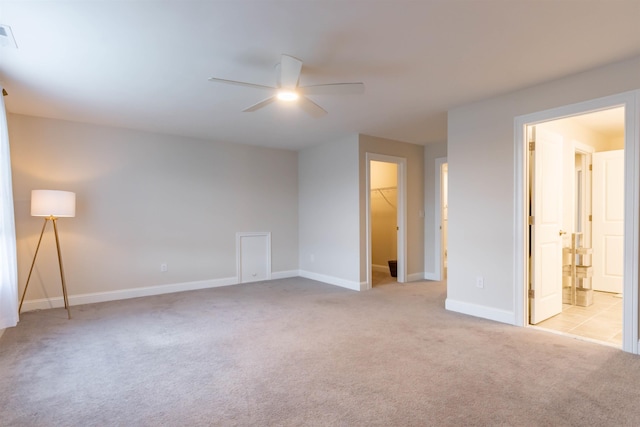 21 Catesby Ln, Londonderry, NH 03053 - unfurnished bedroom featuring light colored carpet, a walk in closet, a closet, a ceiling fan, and ensuite bathroom
