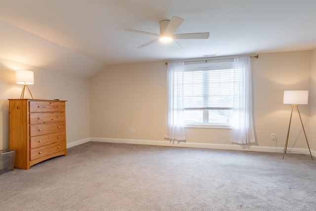 21 Catesby Ln, Londonderry, NH 03053 - unfurnished bedroom featuring light carpet, vaulted ceiling, and a ceiling fan