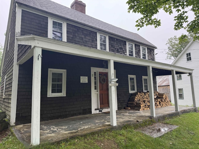 275 Granite Rd, Ossipee, NH 03864 - view of front of home featuring a porch, a chimney, and roof with shingles