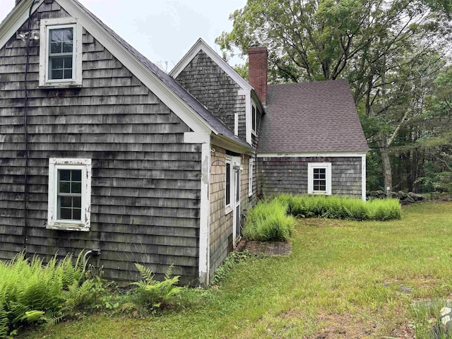 275 Granite Rd, Ossipee, NH 03864 - view of property exterior featuring a chimney and a yard