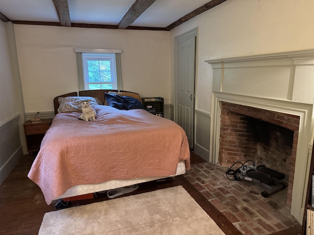 275 Granite Rd, Ossipee, NH 03864 - bedroom with beamed ceiling and a brick fireplace