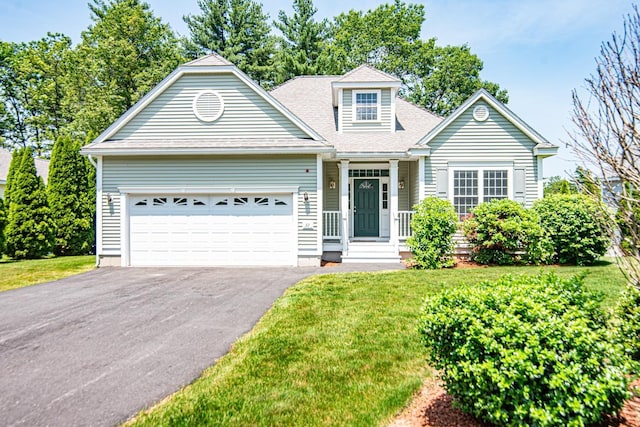 32 Saint Andrews Way, Londonderry, NH 03053 - view of front of house with asphalt driveway, an attached garage, a front yard, and a shingled roof