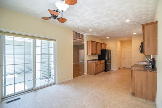 32 Saint Andrews Way, Londonderry, NH 03053 - kitchen featuring black appliances, ceiling fan, brown cabinets, recessed lighting, and dark countertops