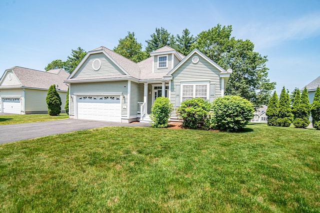 32 Saint Andrews Way, Londonderry, NH 03053 - traditional-style house featuring driveway, an attached garage, and a front lawn