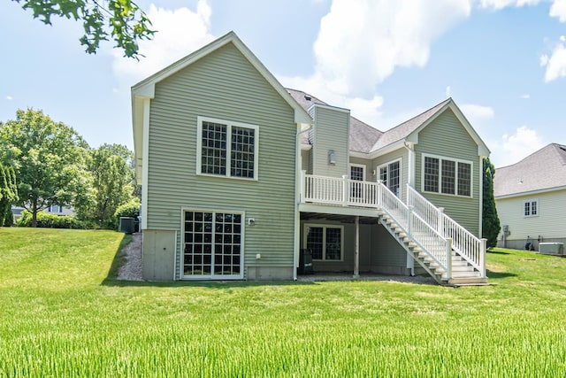32 Saint Andrews Way, Londonderry, NH 03053 - rear view of house featuring stairs, a deck, and a yard