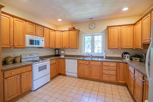 32 Saint Andrews Way, Londonderry, NH 03053 - kitchen with white appliances, dark countertops, light tile patterned floors, recessed lighting, and brown cabinets