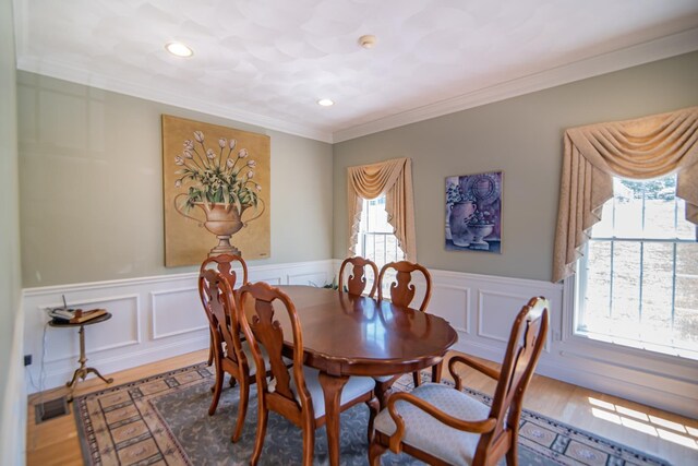 32 Saint Andrews Way, Londonderry, NH 03053 - dining room with a wainscoted wall, crown molding, wood finished floors, recessed lighting, and a decorative wall