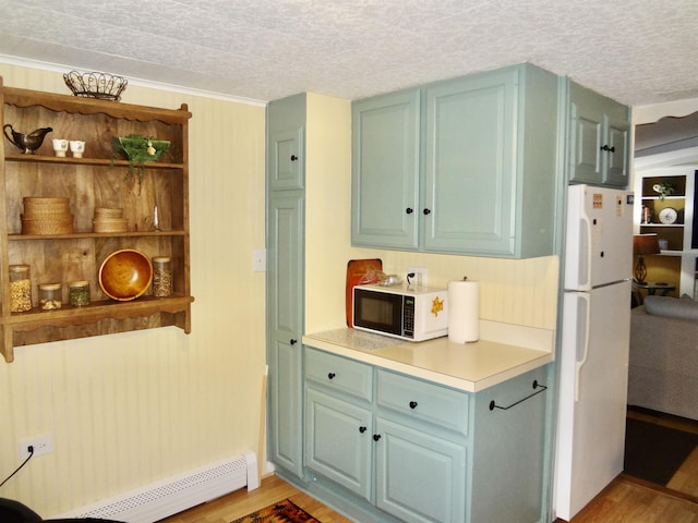 1 Northbrook Rd, Tilton, NH 03276 - kitchen with freestanding refrigerator, open shelves, light wood-style floors, a baseboard heating unit, and a textured ceiling