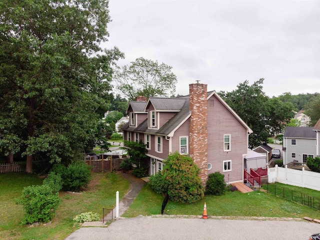5 Gayle Dr Unit L, Derry, NH 03038 - view of property exterior featuring a chimney