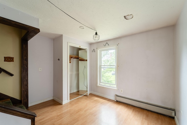 5 Gayle Dr Unit L, Derry, NH 03038 - unfurnished bedroom with a baseboard radiator, light wood finished floors, and a closet