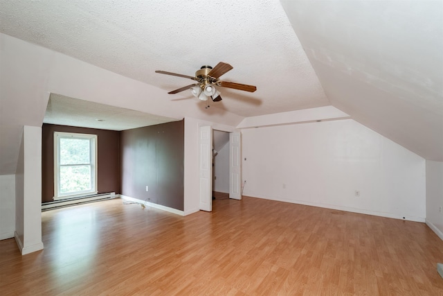 5 Gayle Dr Unit L, Derry, NH 03038 - additional living space featuring baseboard heating, light wood-style flooring, a ceiling fan, vaulted ceiling, and a textured ceiling