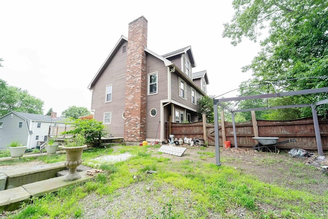 5 Gayle Dr Unit L, Derry, NH 03038 - rear view of house featuring a chimney