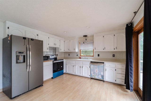 5 Gayle Dr Unit L, Derry, NH 03038 - kitchen featuring stainless steel fridge, dishwasher, electric range oven, white cabinets, and backsplash