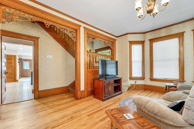 3 Fisher Pl, Claremont, NH 03743 - living area with light wood-style flooring, a chandelier, crown molding, and wallpapered walls