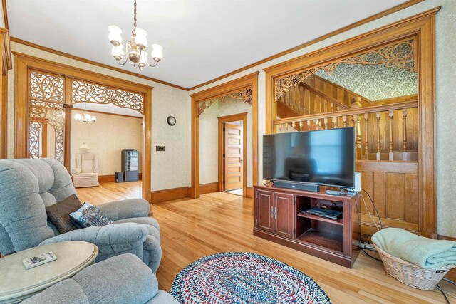 3 Fisher Pl, Claremont, NH 03743 - living area featuring a chandelier, wood finished floors, and crown molding