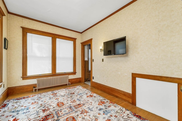 3 Fisher Pl, Claremont, NH 03743 - spare room with radiator heating unit, crown molding, and wood finished floors