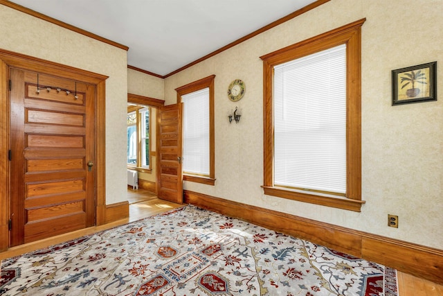 3 Fisher Pl, Claremont, NH 03743 - entryway featuring wood finished floors, radiator, and ornamental molding