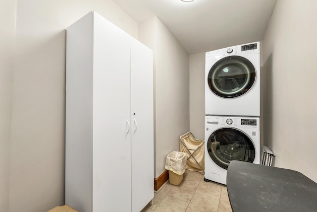 3 Fisher Pl, Claremont, NH 03743 - laundry room with stacked washing machine and dryer and light tile patterned flooring