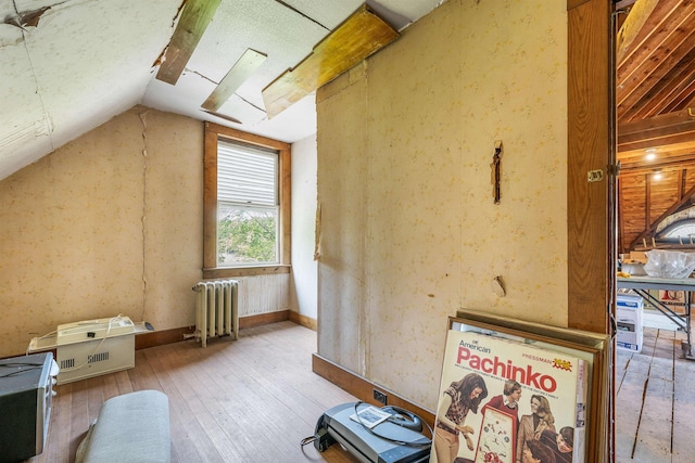 3 Fisher Pl, Claremont, NH 03743 - additional living space with radiator, vaulted ceiling, and hardwood / wood-style flooring