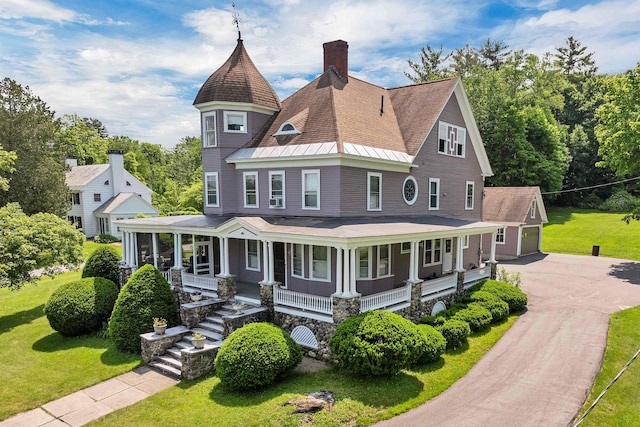 3 Fisher Pl, Claremont, NH 03743 - victorian-style house with a porch, a chimney, a front lawn, a garage, and roof with shingles