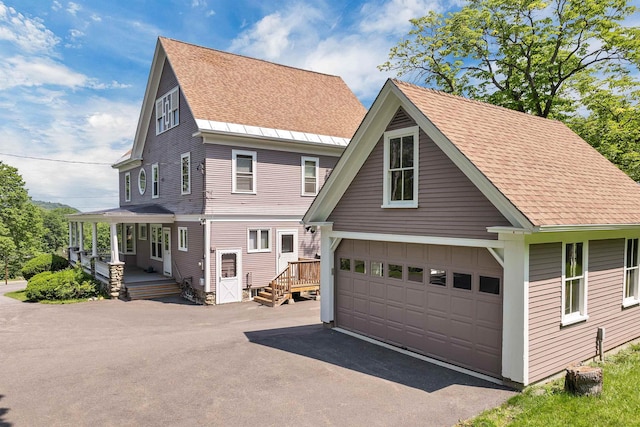 3 Fisher Pl, Claremont, NH 03743 - view of front of home with roof with shingles, a porch, and a garage