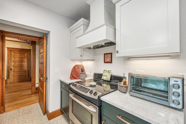 3 Fisher Pl, Claremont, NH 03743 - kitchen featuring electric range, premium range hood, white cabinetry, and light stone countertops