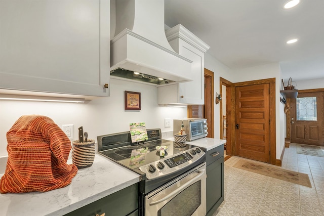 3 Fisher Pl, Claremont, NH 03743 - kitchen featuring stainless steel electric stove, premium range hood, recessed lighting, light stone counters, and white cabinetry
