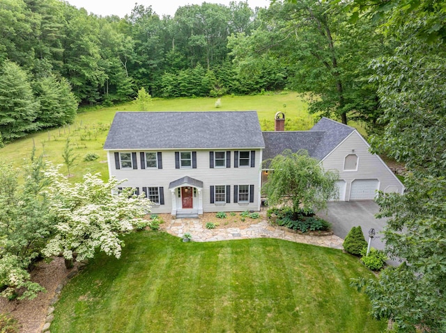146 Old Sandown Rd, Chester, NH 03036 - colonial home featuring a front yard, driveway, a chimney, and a shingled roof