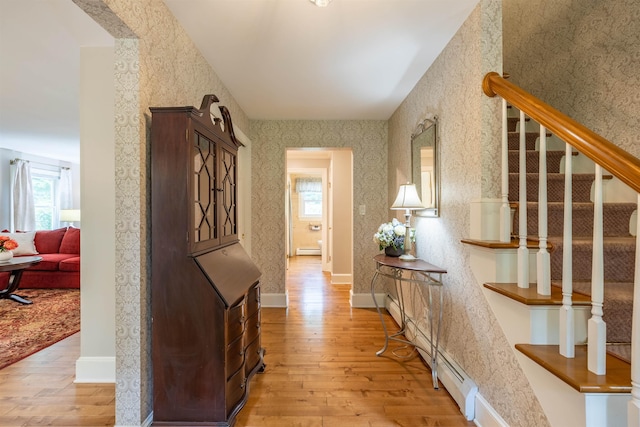 146 Old Sandown Rd, Chester, NH 03036 - hall with light wood-style flooring, stairway, wallpapered walls, and a baseboard heating unit