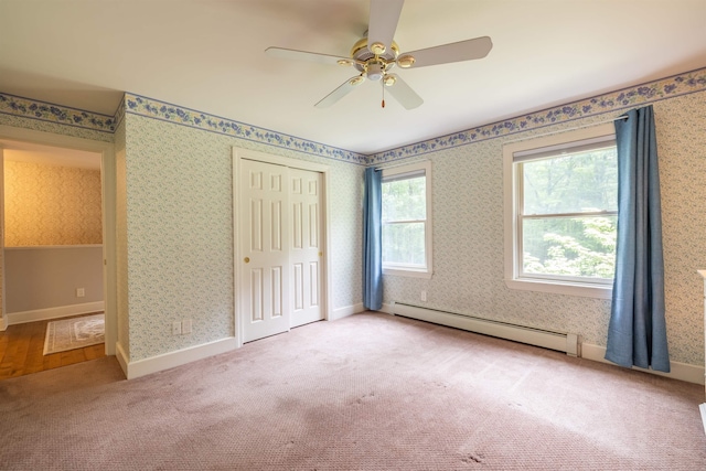 146 Old Sandown Rd, Chester, NH 03036 - unfurnished bedroom with a baseboard radiator, wallpapered walls, carpet flooring, a closet, and a ceiling fan