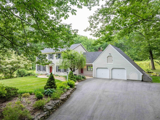 146 Old Sandown Rd, Chester, NH 03036 - view of front of property featuring asphalt driveway, a front lawn, roof with shingles, a garage, and a chimney