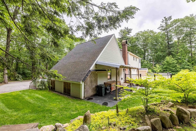 146 Old Sandown Rd, Chester, NH 03036 - view of side of property featuring a yard, a chimney, a patio, and a shingled roof
