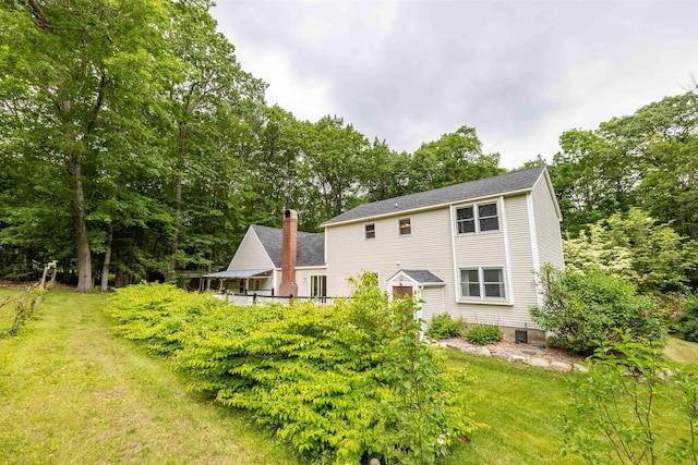 146 Old Sandown Rd, Chester, NH 03036 - rear view of house featuring a yard and a chimney