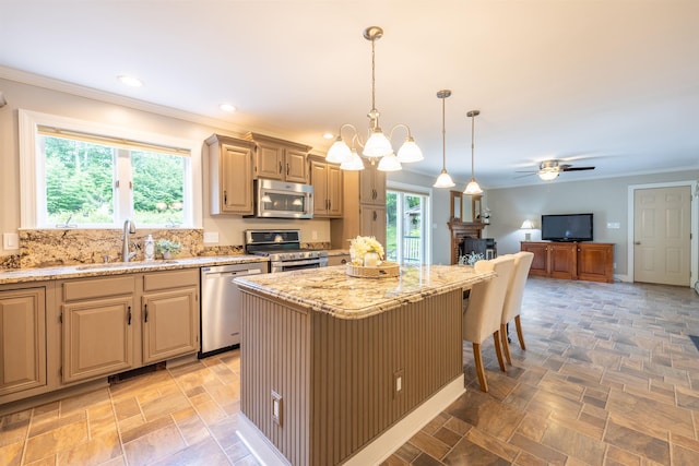 146 Old Sandown Rd, Chester, NH 03036 - kitchen featuring appliances with stainless steel finishes, light stone counters, crown molding, a breakfast bar, and hanging light fixtures