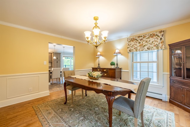 146 Old Sandown Rd, Chester, NH 03036 - dining area featuring a chandelier, baseboard heating, light wood-style floors, ornamental molding, and a wainscoted wall