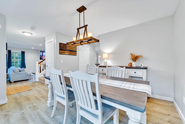 27 Westbrook Dr, New Ipswich, NH 03071 - dining space featuring light wood-style floors, stairs, and a chandelier