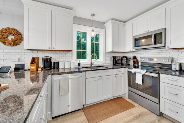 27 Westbrook Dr, New Ipswich, NH 03071 - kitchen with stainless steel appliances, backsplash, light wood-type flooring, and white cabinets