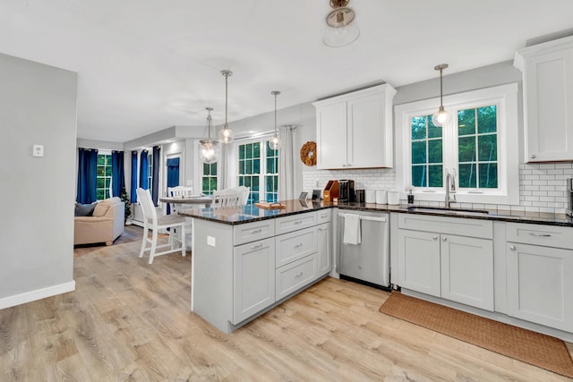 27 Westbrook Dr, New Ipswich, NH 03071 - kitchen featuring stainless steel dishwasher, decorative backsplash, light wood-style floors, and a peninsula
