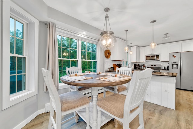 27 Westbrook Dr, New Ipswich, NH 03071 - dining space featuring healthy amount of natural light and light wood-style floors