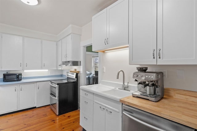 19 Highland St, Concord, NH 03301 - kitchen with appliances with stainless steel finishes, under cabinet range hood, and white cabinets