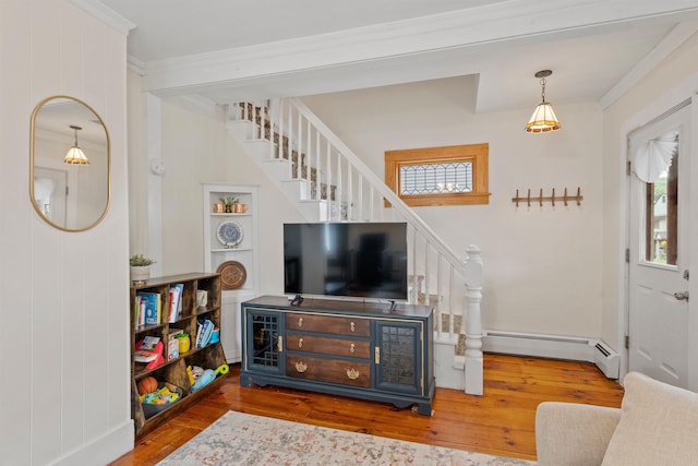 19 Highland St, Concord, NH 03301 - living area featuring stairway, wood finished floors, a baseboard radiator, and ornamental molding