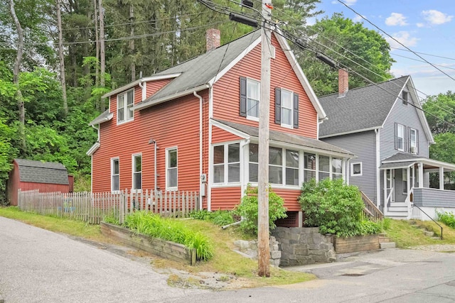 19 Highland St, Concord, NH 03301 - view of home's exterior with a chimney, a sunroom, and a shingled roof