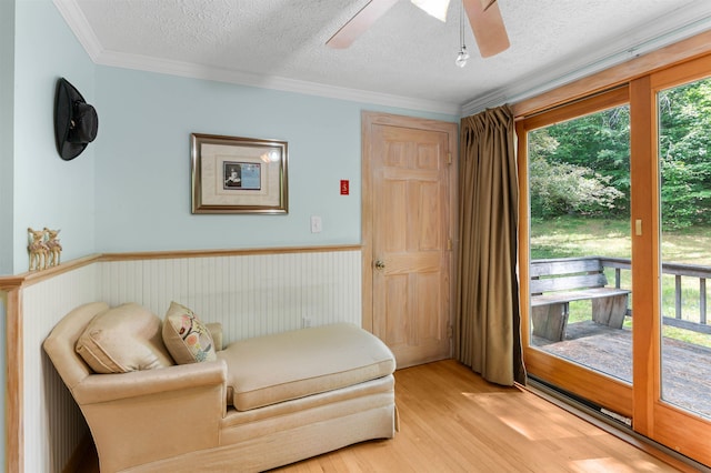 70 Tabor Cir, Albany, NH 03818 - sitting room with a textured ceiling, healthy amount of natural light, ceiling fan, light wood-style flooring, and wainscoting