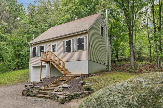 24 Meredith Center Rd, Meredith, NH 03253 - view of front facade with stairway, driveway, and a garage