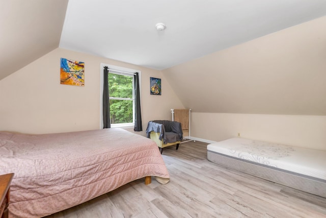 24 Meredith Center Rd, Meredith, NH 03253 - bedroom with light wood finished floors and lofted ceiling
